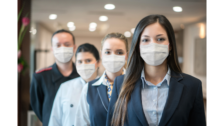 Group of hotel workers wearing facemask