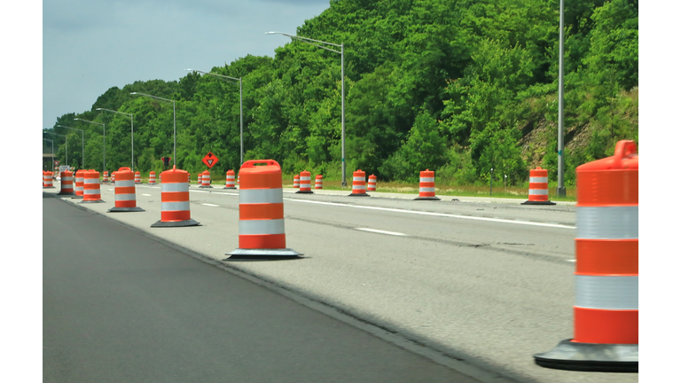 Orange construction barrels along the highway