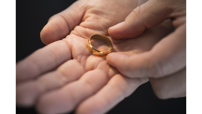 Hand holding wedding ring