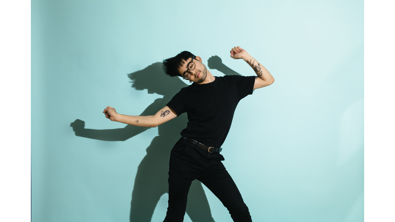 Gay Man Dancing Wildly on Colorful Background