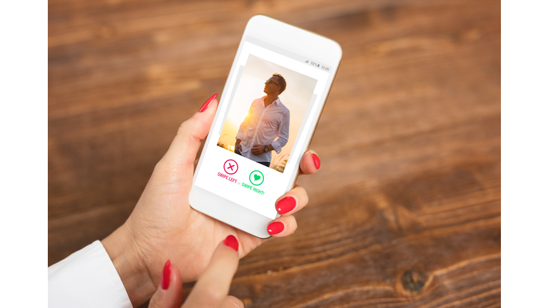 Woman using dating app and swiping user photos