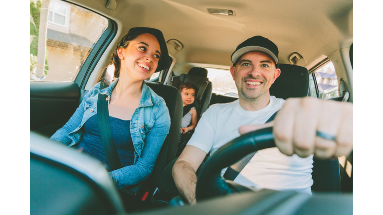 Smiling Family Traveling In Car