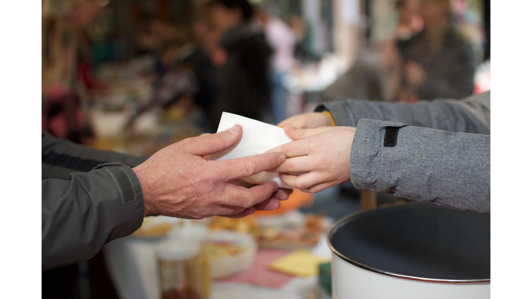 Cropped Image Of Volunteer Giving Food To Person