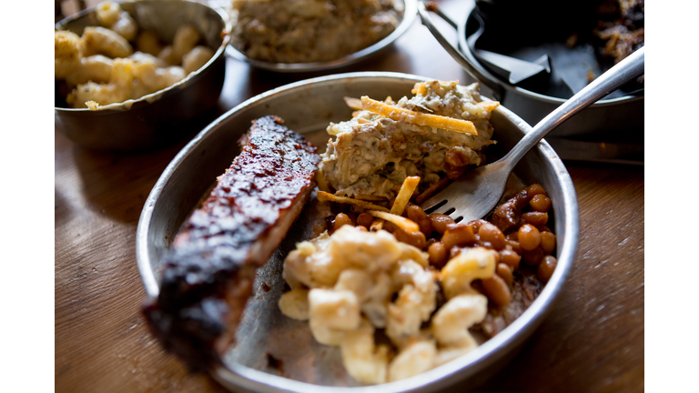 Variety of barbecue food with side dishes on table