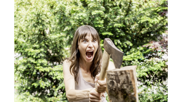 Screaming woman chopping wood