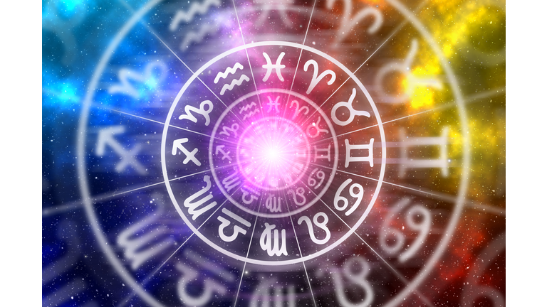 Zodiac signs inside of horoscope circle on universe background