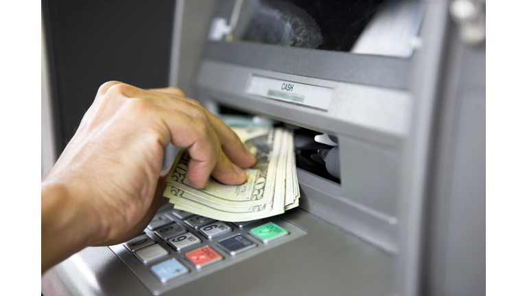 Taking money from ATM machine