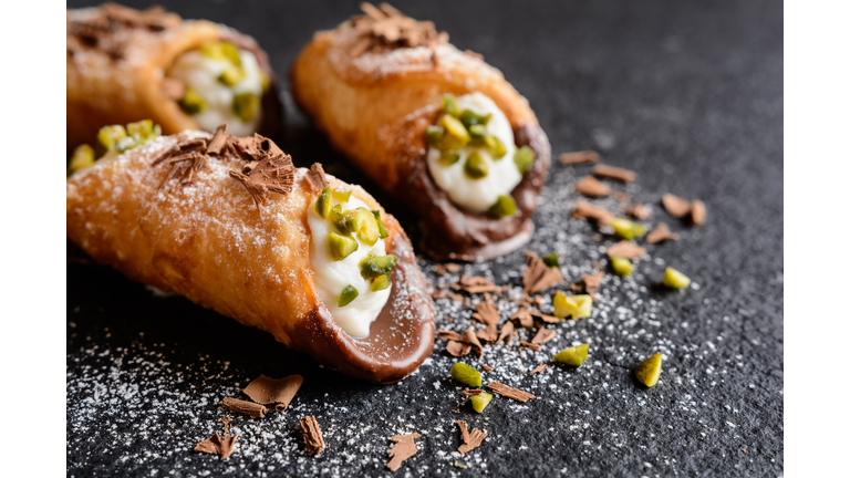 Traditional Sicilian cannoli stuffed with ricotta and pistachios