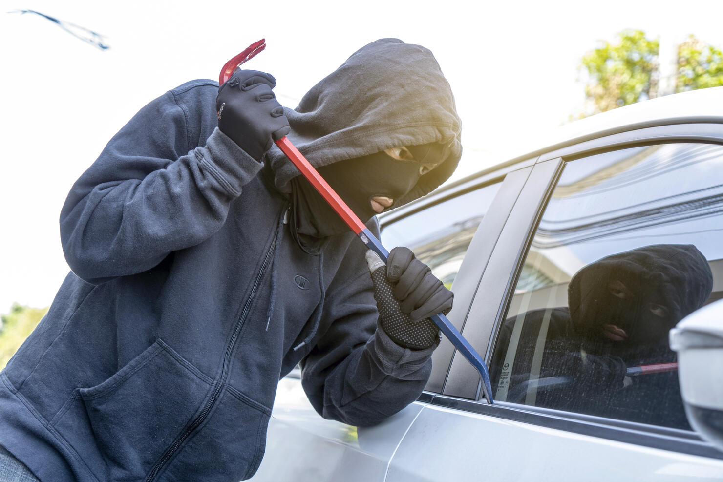 car theft - thief trying to break into the vehicle