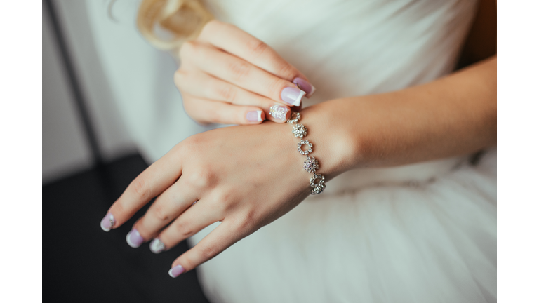 Wedding. Wedding day. Luxury bracelet on the bride's hand close-up Hands of the bride before wedding. Wedding accessories. Selective focus.