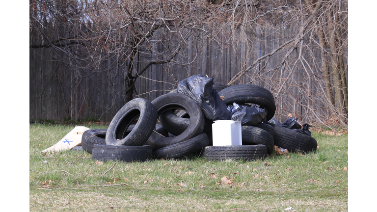 Old tires and trash dump on an abandoned lot