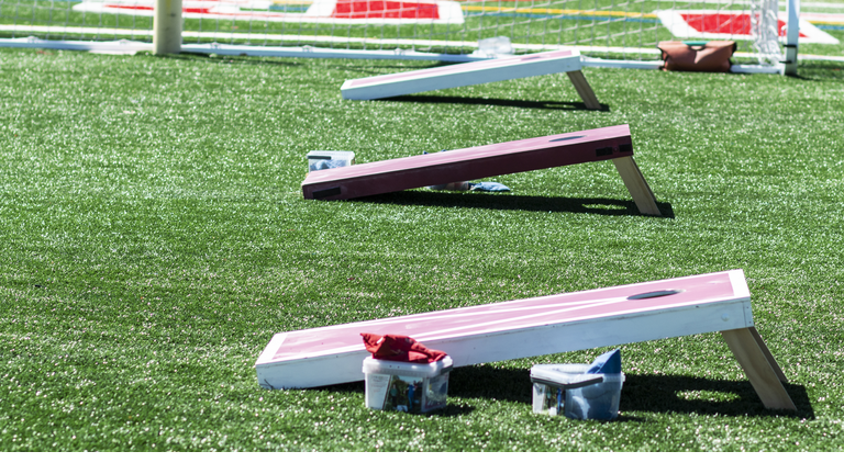 Three homemade corn hole game boards side by side
