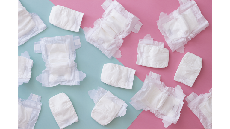 High Angle View Of Diapers Over Colored Background