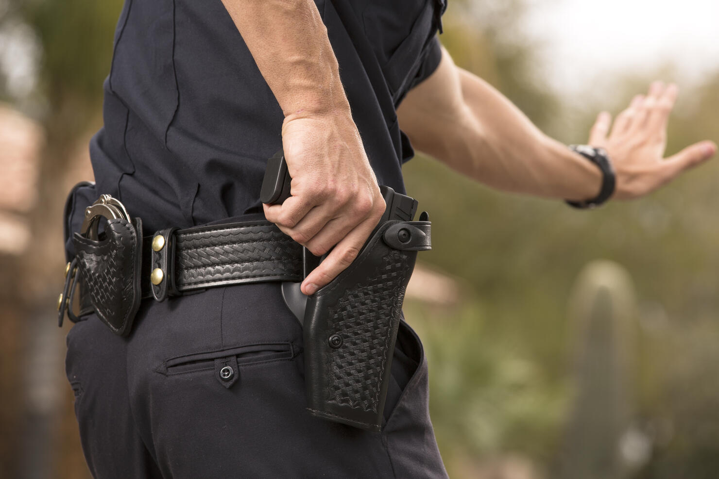 Policeman preparing to draw his gun