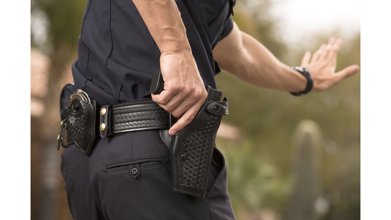 Policeman preparing to draw his gun