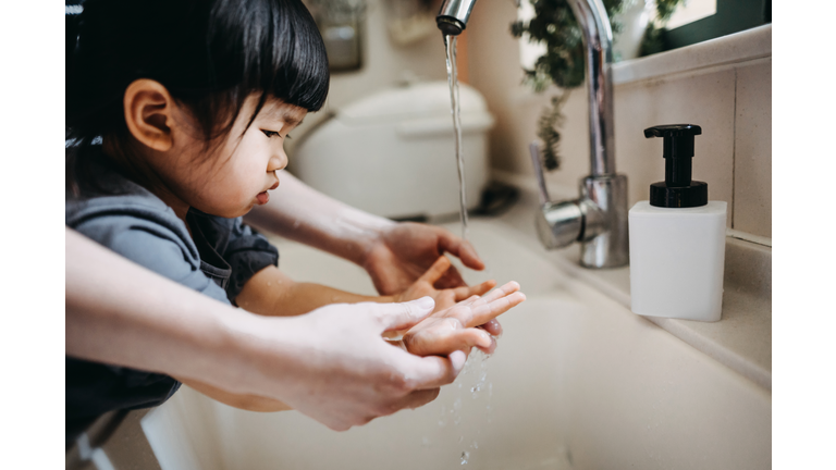 Cropped shot of a mother and little daughter maintaining hands hygiene and washing their hands with soap together in the sink