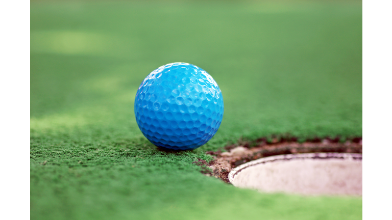 Blue Mini Golf Ball On Grass Near Hole