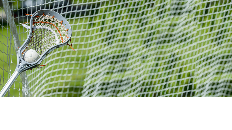 Abstract view of a lacrosse stick scooping up a ball