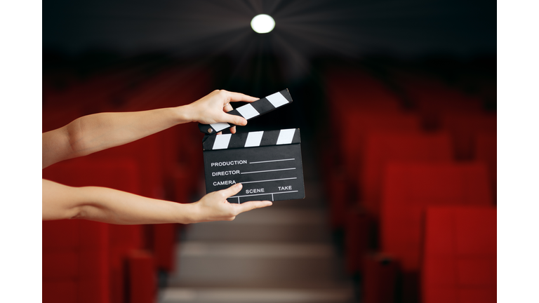 Hands Holding Director Movie Clapper in Cinema Theatre