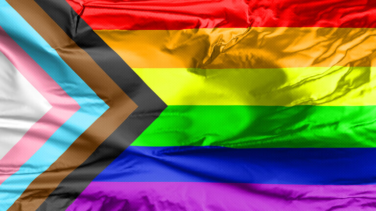 Waving flag of the new LGBT community with inclusion and progression colours.