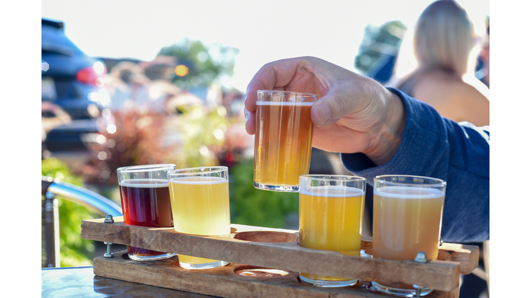 Man sampling beer from flight