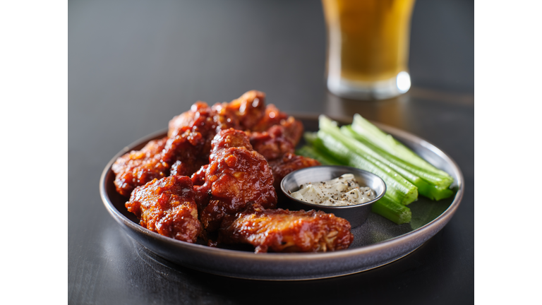 boneless bbq chicken wings with beer glass in background