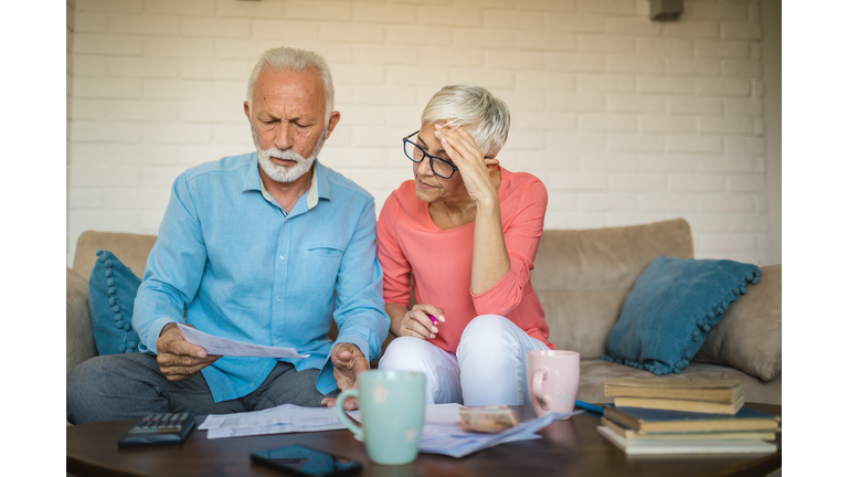 Senior couple brainstorming the solution to a financial problem