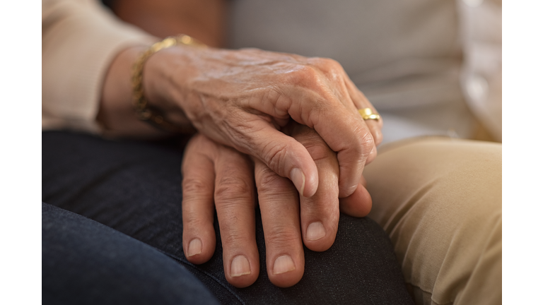 Senior couple holding hands