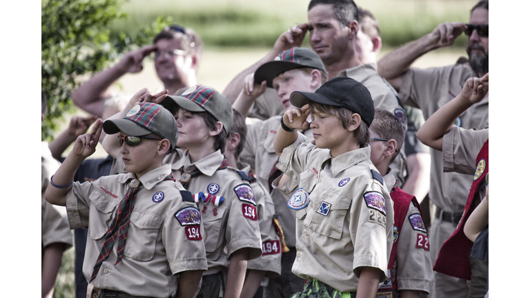 A troop of young, Weblo Boy Scouts salute during an America flag ceremony at their camp in Colorado.