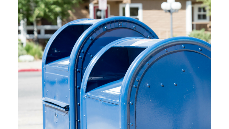 Two blue post office mail boxes