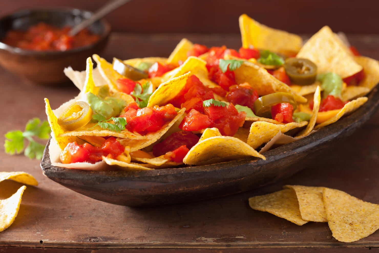 nachos loaded with salsa, cheese and jalapeno