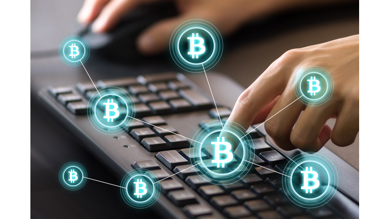 Digital Composite Image Of Cropped Hands Using Computer Keyboard By Bitcoin Icons