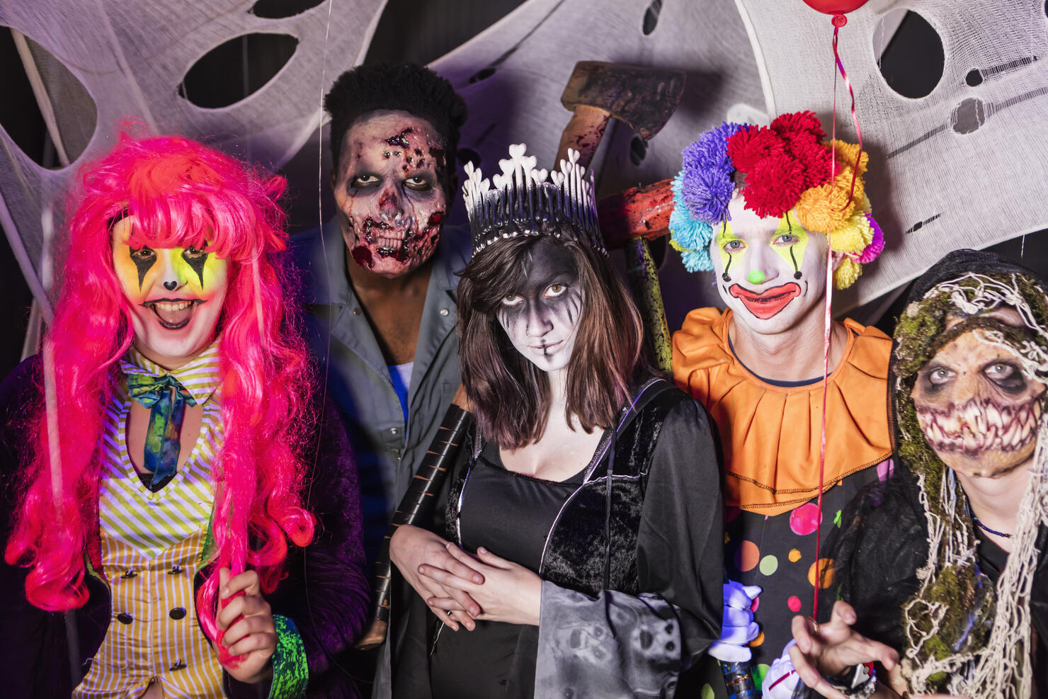 Zombies, ghouls and a clown in halloween haunted house