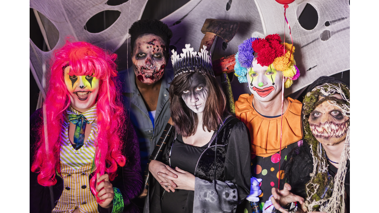 Zombies, ghouls and a clown in halloween haunted house