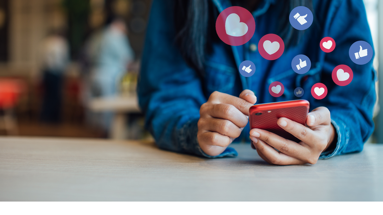 Midsection Of Woman Using Smart Phone On Table In Cafe