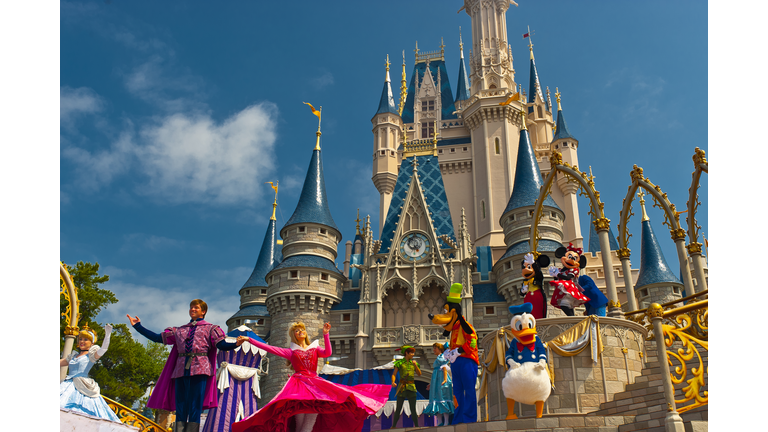 Disney characters perform in front of the Cinderella Castle