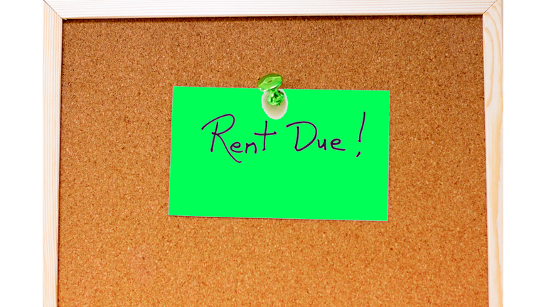 "Rent Due!" Green Sticky Note Reminder on Cork Board