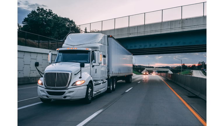 18 wheeler truck on road at night