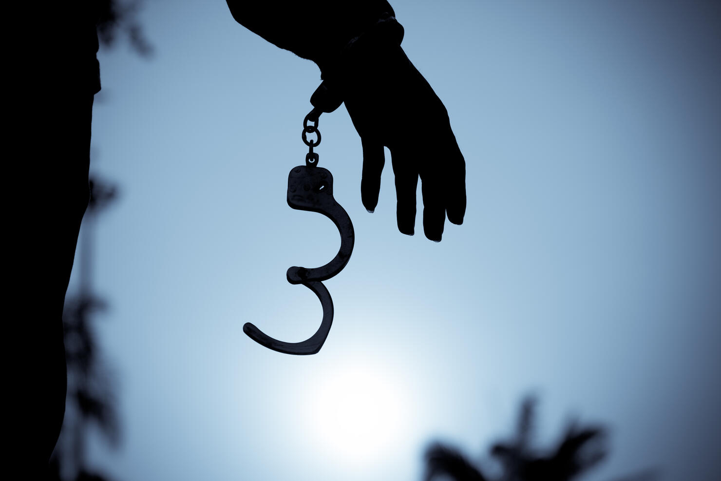 Cropped Hand Of Men Removing Handcuffs