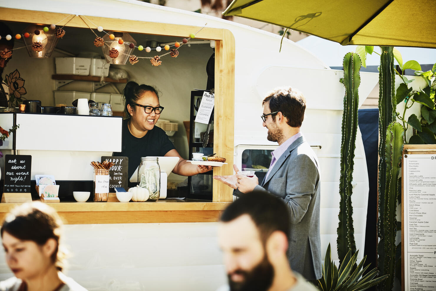 Businessman receiving food order from owner of food truck