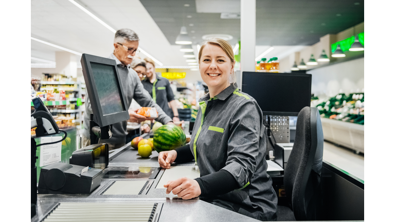 Portrait Of Cashier Smiling While Working