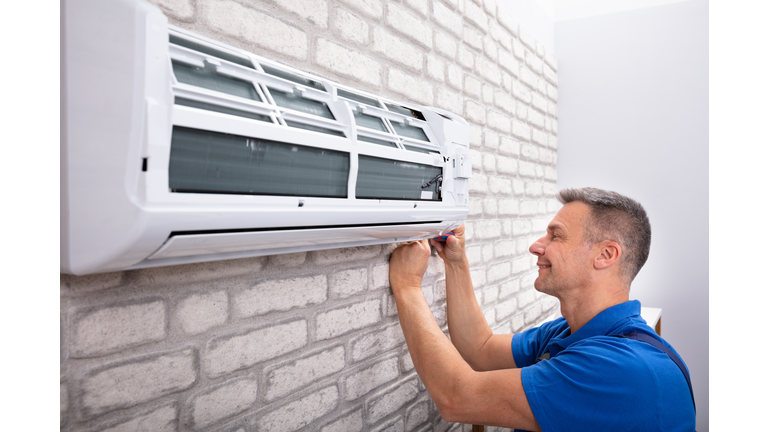 Technician Fixing Air Conditioner