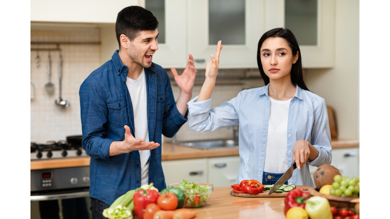 Young couple arguing in the modern kitchen