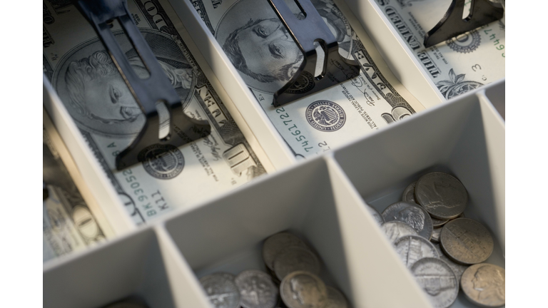 U.S. bills and coins in cash register