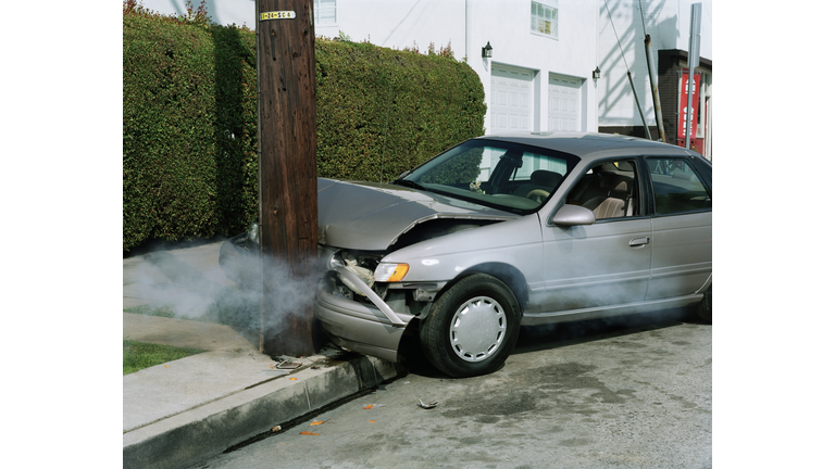 Car crash against telephone pole by road