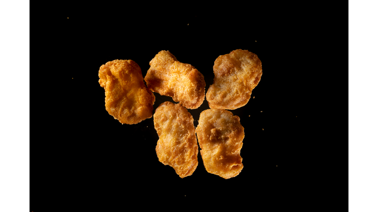 fried chicken Nuggets flying in mid air view from above