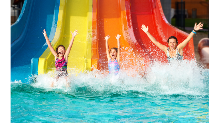 Family on water slide at aquapark, Romania.