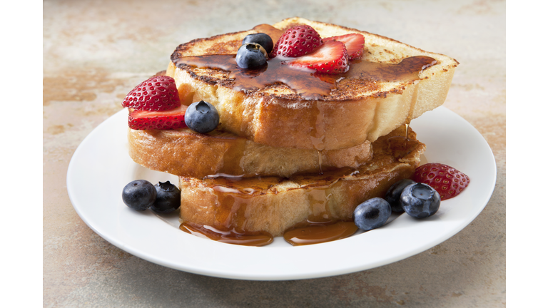 French Toast With Fruit and Syrup on a Marble Countertop.