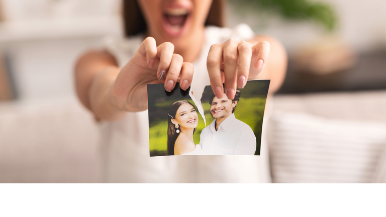 Unrecognizable Girl Tearing Apart Photo Of Happy Couple Indoor, Cropped