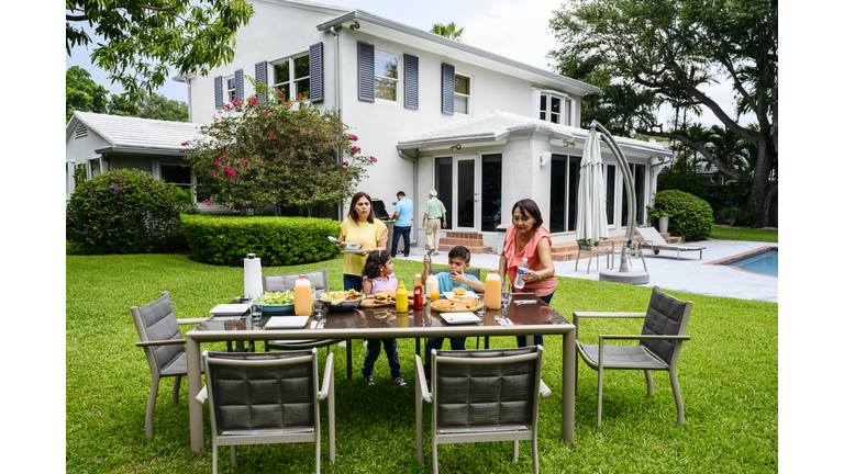 Latin American family cookout in modern Miami home backyard